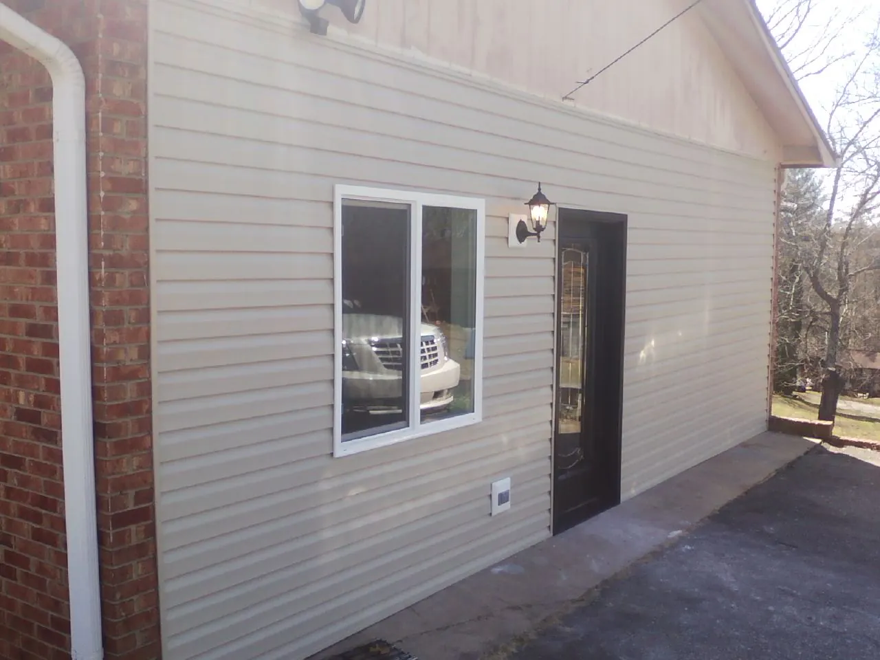 New vinyl siding and entry door on a room addition in Portland